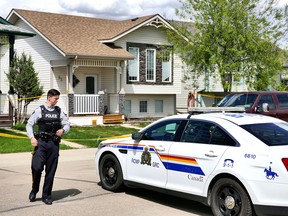 RCMP guard a crime scene at 93 Lister Crescent in Red Deer after finding a 39-year-old man and a six-year-old girl dead inside.