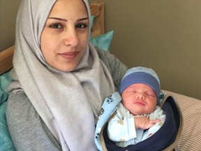 Afraa Bilal holds her newborn son, Justin Trudeau Adam Bilal.