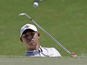 Si Woo Kim chips onto the third green during the final round of The Players Championship golf tournament on May 14, 2017, in Ponte Vedra Beach, Fla.