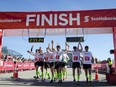 FILE PHOTO: CALGARY, AB MAY 26, 2013 —Team MitoCanada, a group of ten who completed the marathon linked together, celebrate after crossing the finish line at the annual Scotiabank Calgary Marathon on Sunday, May 26, 2013.