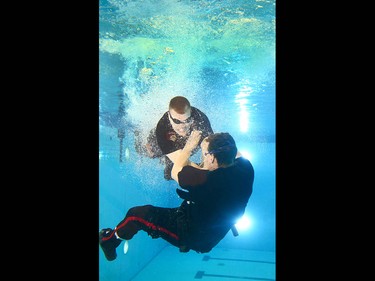 Members of the Calgary Police Service Unit Marine Unit train in the dive tank at Repsol Spaorts Centre in Calgary on Thursday May 11, 2017. The teams' training consists of a number of requirements and includes hand to hand, combat and defensive tactics in, along and under the water. Jim Wells//Postmedia