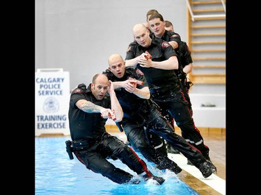 Members of the Calgary Police Service Unit Marine Unit train in the dive tank at Repsol Spaorts Centre in Calgary on Thursday May 11, 2017. The teams' training consists of a number of requirements and includes hand to hand, combat and defensive tactics in, along and under the water. Jim Wells//Postmedia