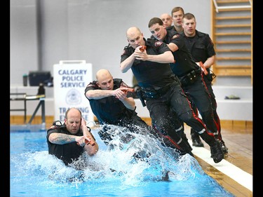 Members of the Calgary Police Service Unit Marine Unit train in the dive tank at Repsol Spaorts Centre in Calgary on Thursday May 11, 2017. The teams' training consists of a number of requirements and includes hand to hand, combat and defensive tactics in, along and under the water. Jim Wells//Postmedia