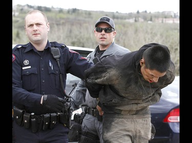 Calgary Police take into custody two men after a collision on Parkdale Blvd and Shaganappi Tr NW about 1 pm in Calgary on Tuesday May 9, 2017. The alleged stolen vehicle crashed into at least two other vehicles. The men were taken into custody in a parking lot near Edworthy Park. The were treated at scene by EMS for a variety of injuries. Jim Wells//Postmedia