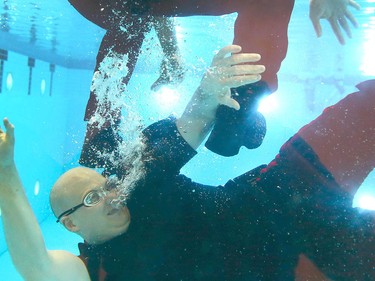 Members of the Calgary Police Service Unit Marine Unit train in the dive tank at Repsol Spaorts Centre in Calgary on Thursday May 11, 2017. The teams' training consists of a number of requirements and includes hand to hand, combat and defensive tactics in, along and under the water. Jim Wells//Postmedia