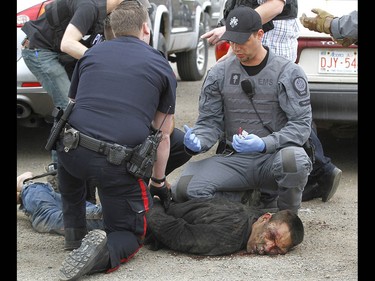 Calgary Police take into custody two men after a collision on Parkdale Blvd and Shaganappi Tr NW about 1 pm in Calgary on Tuesday May 9, 2017. The alleged stolen vehicle crashed into at least two other vehicles. The men were taken into custody in a parking lot near Edworthy Park. The were treated at scene by EMS for a variety of injuries. Jim Wells//Postmedia