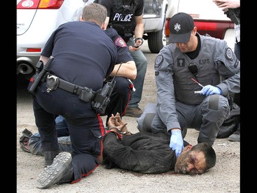 Calgary Police take into custody two men after a collision on Parkdale Blvd and Shaganappi Tr NW about 1 pm in Calgary on Tuesday May 9, 2017. The alleged stolen vehicle crashed into at least two other vehicles. The men were taken into custody in a parking lot near Edworthy Park. The were treated at scene by EMS for a variety of injuries. Jim Wells//Postmedia