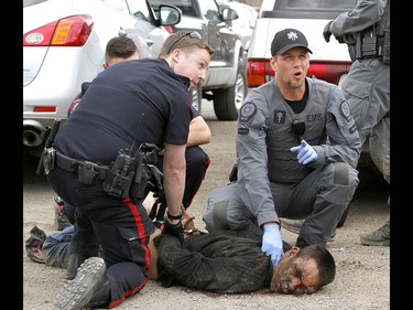 Calgary Police take into custody two men after a collision on Parkdale Blvd and Shaganappi Tr NW about 1 pm in Calgary on Tuesday May 9, 2017. The alleged stolen vehicle crashed into at least two other vehicles. The men were taken into custody in a parking lot near Edworthy Park. The were treated at scene by EMS for a variety of injuries. Jim Wells//Postmedia