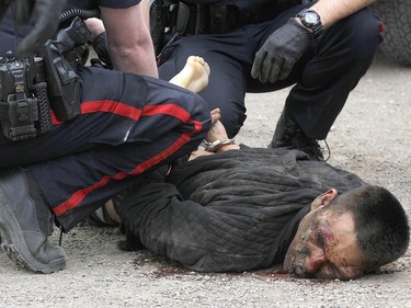 Calgary Police take into custody two men after a collision on Parkdale Blvd and Shaganappi Tr NW about 1 pm in Calgary on Tuesday May 9, 2017. The alleged stolen vehicle crashed into at least two other vehicles. The men were taken into custody in a parking lot near Edworthy Park. The were treated at scene by EMS for a variety of injuries. Jim Wells//Postmedia