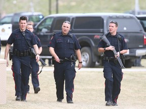 Calgary Police leave Ernest Manning High School in southwest Calgary on Friday May 5, 2017 following a lockdown. Police later located a suspect in the school without injury or incident after a short search at the school while students sheltered in place. No injuries were reported in the incident. Jim WellsPostmedia