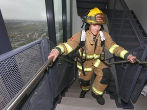 A Calgary Firefighter hits the last couple of stairs during the Calgary Firefighter Stairclimb held at the Bow Building in downtown Calgary on Sunday May 7, 2017. More than 500 firefighters from across North America will suit up and climb the 1,204 steps of the Bow building to raise awareness of cancer and funds for cancer programs. Jim Wells//Postmedia