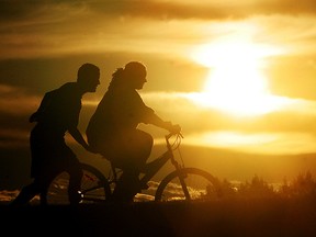 Cyclists in Fort McMurray. AccuWeather is forecasting a hot, dry summer for the prairie provinces.