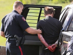 Police arrest a man near Max Bell arena suspected of robbing a bank on Thursday, May 18 2017. Gavin Young/Postmedia Network