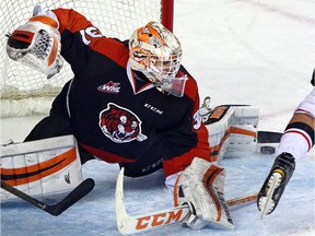 Medicine Hat Tigers goalie Nick Schneider makes a save against the Calgary Hitmen at the Scotiabank Saddledome in Calgary, Alta., on February 10, 2017.
