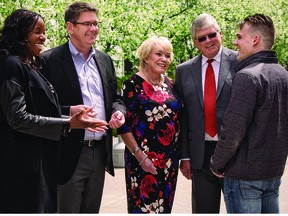 University of Calgary student entrepreneurs Erica Hughes (far left) and Jesse Roy-Cote (far right) share ideas with Derrick, Diane, and Doug Hunter. Photo credit: Courtesy University of Calgary