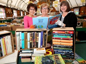 Volunteers Pat LaTouche, left, Darlene Nemeth and Marj Challand sort through books at the annual Servants Anonymous book sale at Crossroads Market in Calgary on Tuesday May 9, 2017. Leah Hennel/Postmedia