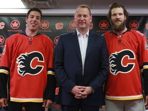 Calgary Flames GM Brad stands with new player Travis Hamonic, left and Mike Smith at the Scotiabank Saddledome in Calgary on Monday June 26, 2017.