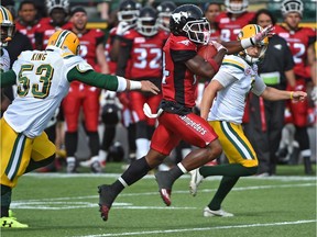 Calgary Stampeders kick-returner Roy Finch runs past Edmonton Eskimos players en route to a punt-return touchdown during CFL pre-season action in Edmonton on June 11, 2017.