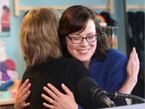 Alberta Premier Rachel Notley, left, hugs Justice Minister Kathleen Ganley, who is expecting her first child in November,  during the announcement of the top Alberta baby names of 2016 at Babies in Arms Boutique in Calgary on June 16, 2017. Leah Hennel/Postmedia