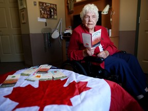 One of Confederation Park's founders Amelia (millie) Smith looks at some of the brochures she saved form the parks 1967 dedication at her home in Calgary, on Friday June 30, 2017. Leah Hennel/Postmedia
Leah Hennel, Leah Hennel/Postmedia