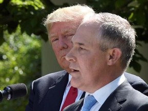 President Donald Trump listens as EPA Administrator Scott Pruitt speaks in the Rose Garden of the White House in Washington, Thursday, June 1, 2017, following Trump&#039;s announcement that the U.S. will withdraw from the Paris climate change accord. (AP Photo/Susan Walsh)