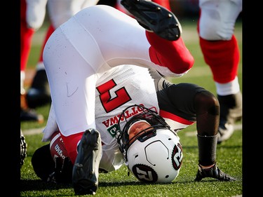 Ottawa Redblacks Trevor Harris is knocked to the turf by the Calgary Stampeders during CFL football in Calgary. AL CHAREST/POSTMEDIA