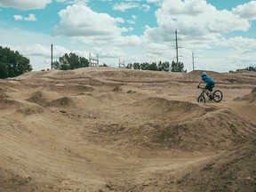 A loan BMX rider takes on the mounds of dirt and rock at the Fish Creek Mountain Bike Skills Park.