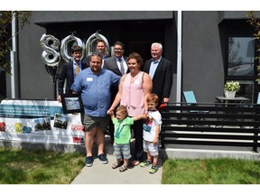 Celebrating a milestone in attainable home ownership are, front row, Bill Douros, Vicky Koutroumpi, and their children Pano and Nikolas; back row, John Harrop, president and CEO of Attainable Homes Calgary, Greg Gutek, president and founder, Partners Development Group, Mayor Naheed Nenshi and Coun. Ward Sutherland.