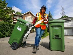 City crews deliver green carts to homes in Lakeview Village on Monday June 5, 2017. As the city wide rollout of the new composting program begins.