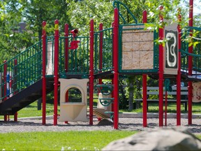 Plywood barriers mark where two slides have been removed from the children's playground at Rotary Park in Crescent Heights.