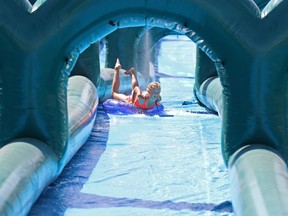 Calgarians beat the heat as they try out the 250 metre long waterslide at WinSport in Calgary on Sunday August 20, 2016. Gavin Young/Postmedia