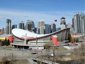 The Saddledome stands out against the Calgary skyline.