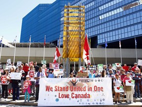 A group of anti-fascists, pro immigration and anti-racism rally goers shared stories of discrimination and shared a message of support for Syrian refugees at City Hall in Calgary, Alta., on June 24, 2017. A few people came to share alternative thoughts.