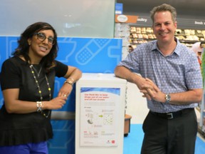 Sonal Ejner, pharmacy professional services manager Calgary Co-op, and Lee Jackson, biology professor, University of Calgary, next to Medi-Bin.