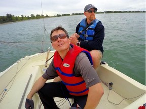 Calgary sailor Chris Lemke (in blue lifejacket) will be taking off for Hawaii in the Transpacific Yacht Race starting July 3. Lemke and friend Jonathan Rose took to the Glenmore Reservoir in Calgary, Alta., on June 19, 2017. Ryan McLeod/Postmedia Network