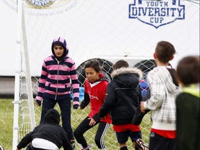 Cold and rainy but that didn't stop the kids involved in the Kiwanis Diversity Cup from playing a little footy at the 15th Annual event at Forest Lawn Athletic Park in Calgary, Alta., on June 10, 2017. Ryan McLeod/Postmedia Network