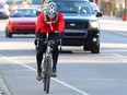 Cyclists ride in the designated bike lane on northbound 10 St and 5 Ave NW in Calgary