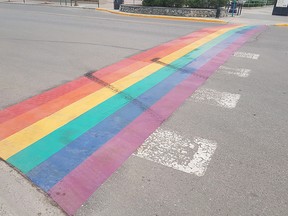 Tire marks are seen on a rainbow-painted crosswalk in Whitehorse, Yukon on June 13, 2017. A crosswalk has also been vandalized in Lethbridge.