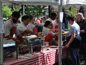 Volunteers serve up food at Calgary's Feeding the 5000 event at Olympic Plaza on Thursday, June 15, 2017. Supplied photo