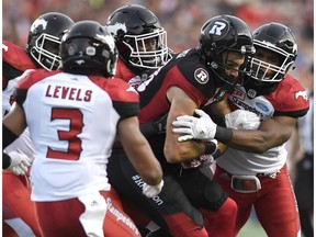 Ottawa Redblacks' Brad Sinopoli (88) fends off the Calgary Stampeders' defence during first half CFL action in Ottawa on Friday, June 23, 2017.