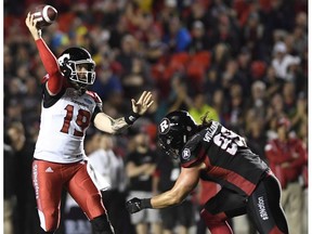 Calgary Stampeders quarterback Bo Levi Mitchell (19) throws the ball as Ottawa Redblacks' Connor Williams (99) rushes forward, during second half CFL action in Ottawa on Friday, June 23, 2017.