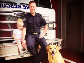 Kurt Stenberg, a Red Deer firefighter/EMT who chased down a school bus in Red Deer earlier this week that was being driven by an allegedly drunk woman, is shown in a handout photo with daughter Kate and dog Cooper. Stenberg says he was compelled to spring into action earlier this week when he saw a school bus on his street hit a tree and speed-limit sign and then keep driving.THE CANADIAN PRESS/HO-Kurt Stenberg MANDATORY CREDIT