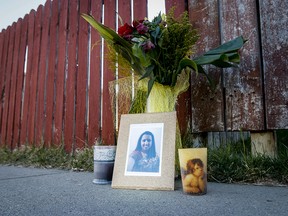 A makeshift memorial with a photo of Sanjula Devi is left outside her Penbrooke home on May 7, 2014.