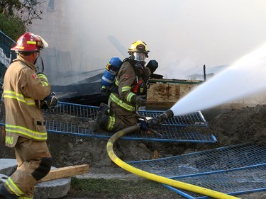 Fire crews battle a two-alarm blaze at  16 St. and 15 Ave. S.W. in the community of Sunalta Monday June 5, 2017 in Calgary, AB. DEAN PILLING/POSTMEDIA