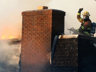 Fire crews battle a two-alarm blaze at  16 St. and 15 Ave. S.W. in the community of Sunalta Monday June 5, 2017 in Calgary, AB. DEAN PILLING/POSTMEDIA