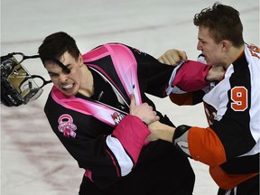 Edmonton Oil Kings defenceman Blake Orban's helmet flies off during a fighting with Medicine Hat Tigers forward Zach Fischer, right, at Rexall Place in Edmonton, February 22, 2015. The Flames selected Fischer in the 2017 NHL Draft.