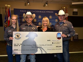 The Calgary Police Rodeo Association made a $10,000 donation to the Missing Child Society of Canada in Calgary, Alta. on Thursday, June 15 2017. From left, Const. Kristin Blades rodeo association president Det. Mike Cavilla, MCSC CEO Amanda Pick, and Const. Steve Weninger.