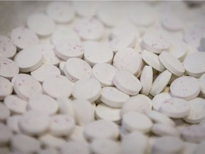 Freshly pressed demonstration pills are speckled with pink powder representing fentanyl to illustrate inconsistent mixing during a fentanyl processing demonstration at the Calgary Police Service headquarters in Calgary, Alta., on Monday, Oct. 17, 2016.