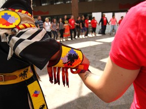 Dancers and the public hold hands in unity to mark National Aboriginal Day at the Harry Hays Building in Calgary June 21, 2017.