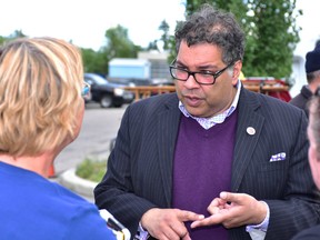 Calgary Mayor Naheed Nenshi speaks to residents during Neighbour Day celebrations in Bowness on Saturday. BRYAN PASSIFIUME/POSTMEDIA NETWORK